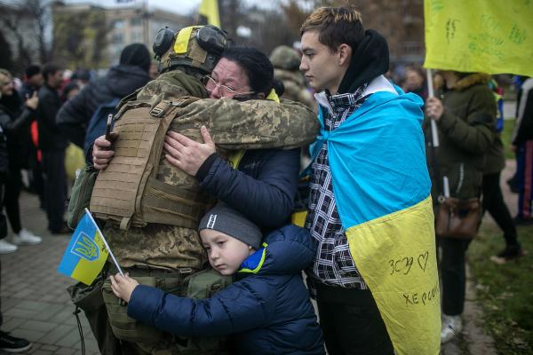 Ukraine-Russia War - A family embraces a Ukrainian soldier at the main square,...