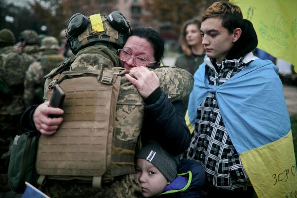 Ukraine-Russia War - A family embraces a Ukrainian soldier at the main square,...