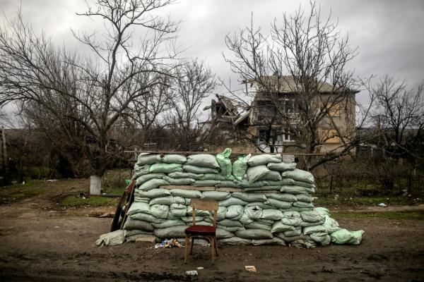 Image from Ukraine-Russia War - Military sandbags in front of a destroyed house in the...