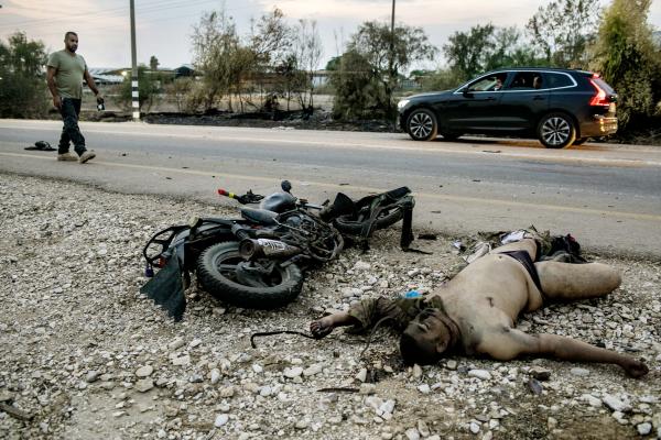 Image from The October 7th War - The body of a Hamas gunman lies by his motorcycle near...