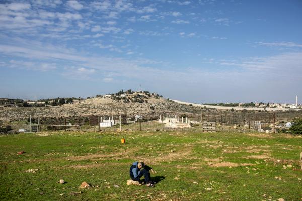 Image from The October 7th War - A young Bedouin boy sits near Arab Al-Aramshe village...