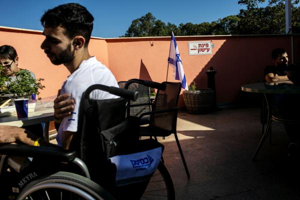 Image from The October 7th War - An IDF soldier (left, on a wheelchair) who was injured...