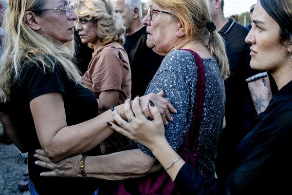 Image from The October 7th War - Friends and family of Yossi Vahav (65), embrace each...