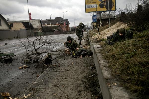 Ukrainian soldiers take cover during heavy shelling by Russian forces at the entrance of Hostomel city. On 24 February 2022, the first day of the 2022 Russian invasion of Ukraine, Hostomel and the Hostomel Airport were &nbsp;attacked by the Russian military during their attempt to capture the whole town. Initially, Ukrainian counter offensives were unable to retake the town but a major Russian withdrawal from Kyiv Oblast in late March and early April saw Hostomel completely retaken from the Russian occupiers.