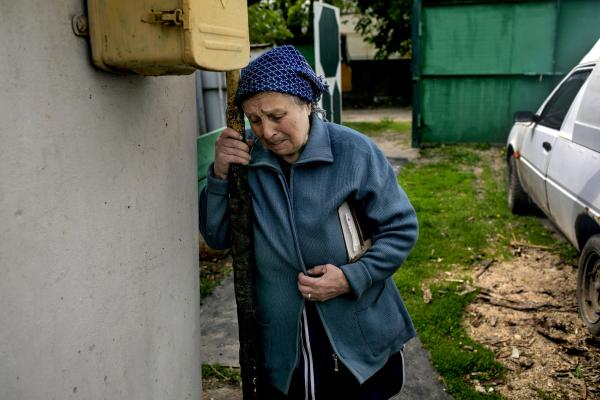 Anastasia Globenka (72) sobes outside her neighbor&#39;s home in the Village of Vilkhivka. (on the outskirts of Kharkiv city) , as she and other elder residents struggle to make ends meet, getting food and supplies from volunteers. The village was liberated by Ukrainian forces on March 26, 2022.