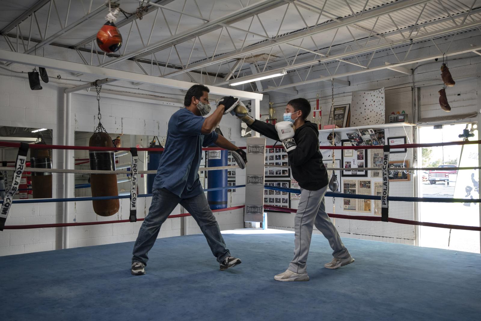 Boxing coach Danny Chavez, left...revent the spread of the virus.