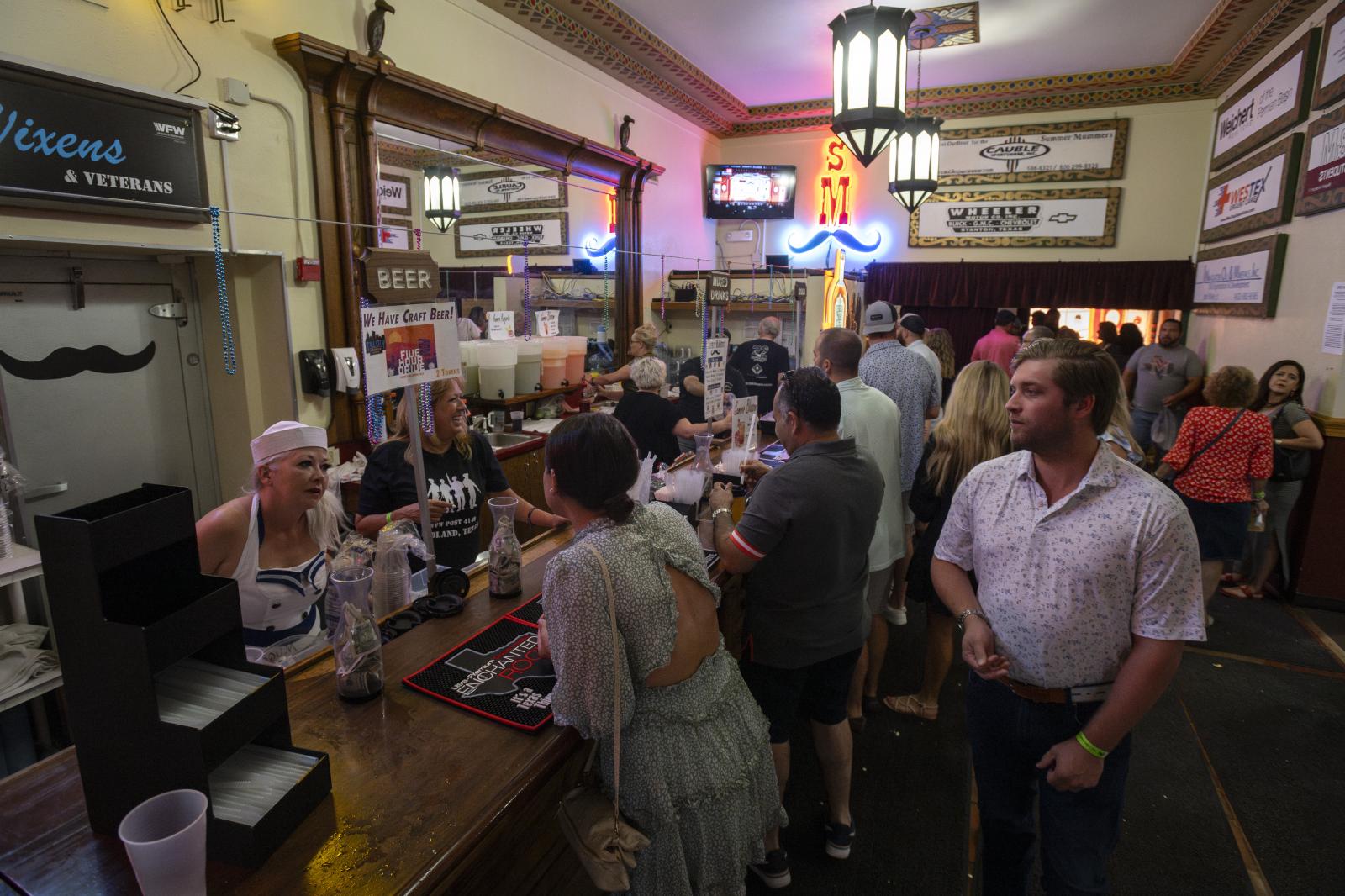 Spectators order drinks from th...ly 31, 2021, in Midland, Texas.