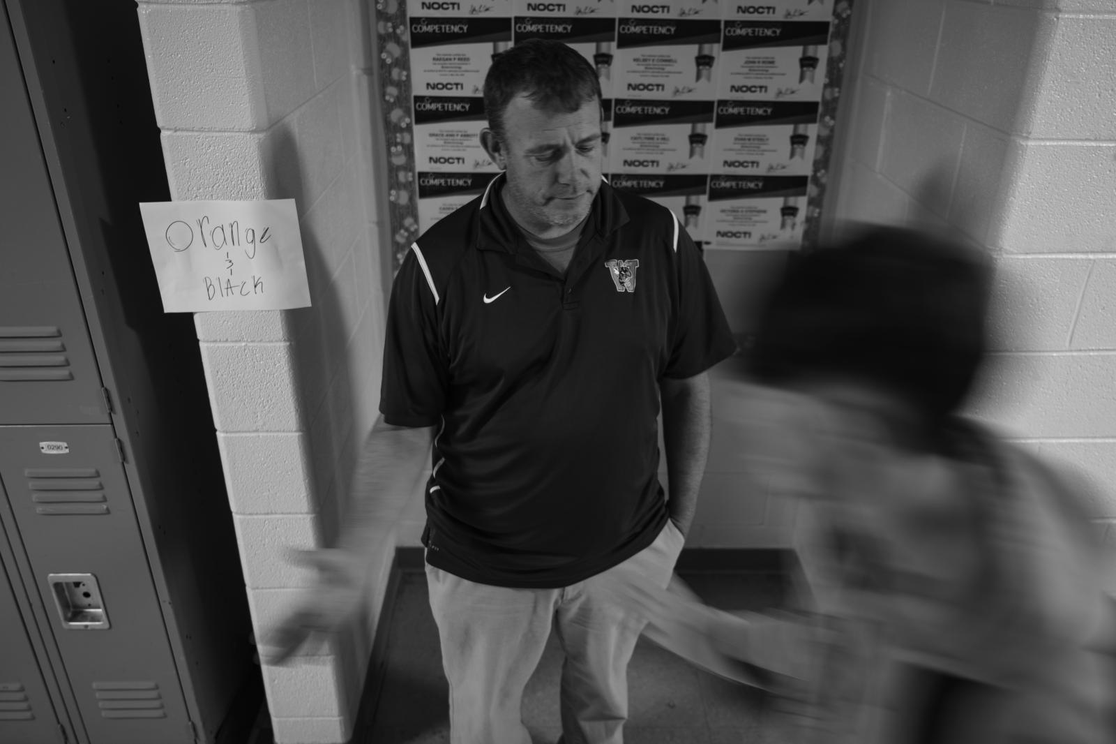 Kind Words, Big Differences - A student high-fives Vaughn as he watches students walk through the halls to their next class...