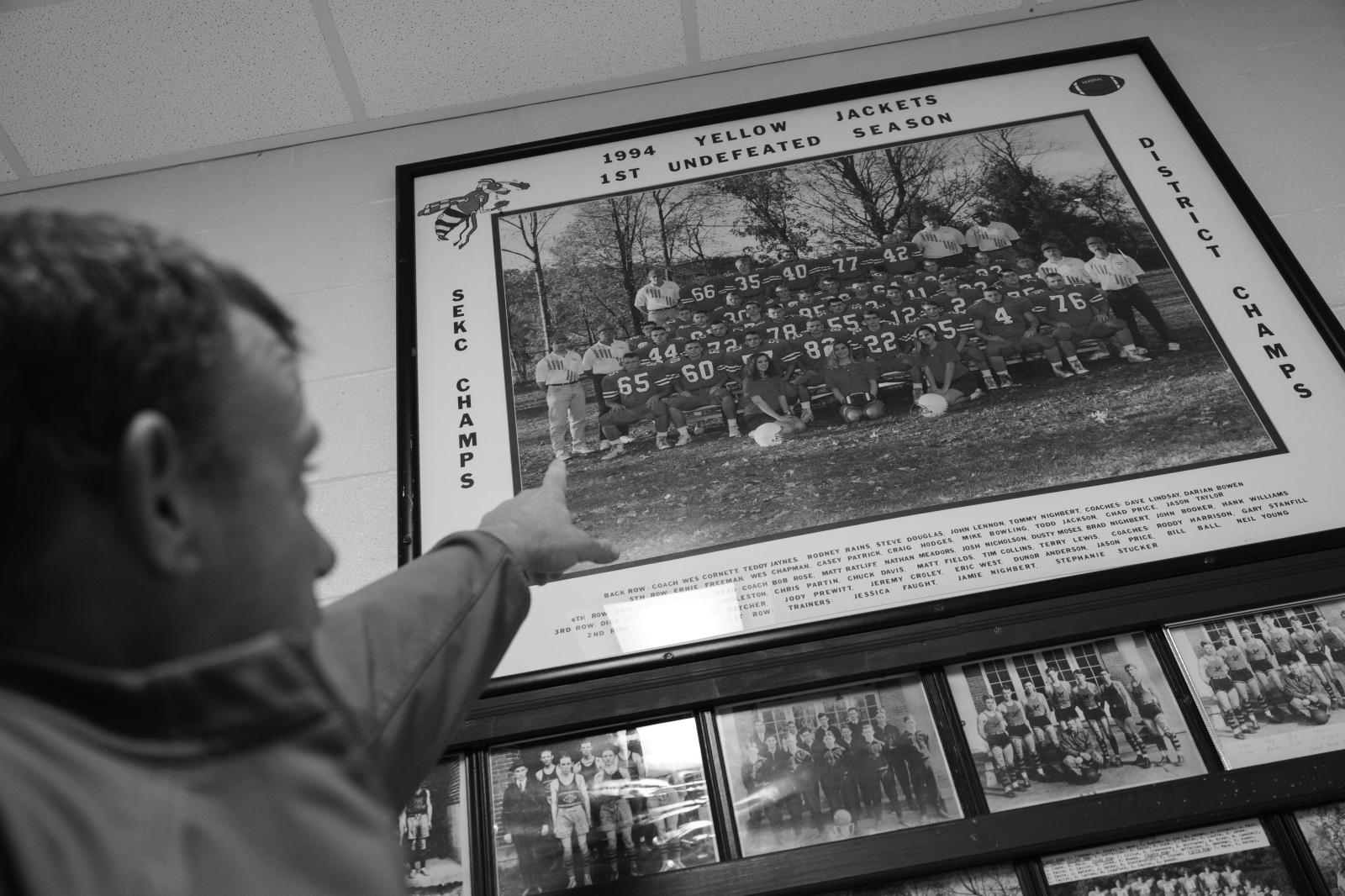 Kind Words, Big Differences - Vaughn points to himself in a football team photo from 1994 while giving a tour of the...