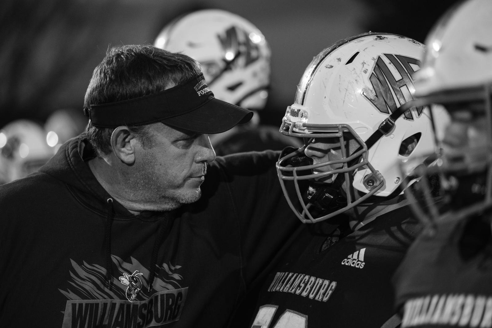 Kind Words, Big Differences - Vaughn speaks to a defensive lineman on the sideline during their homecoming game.