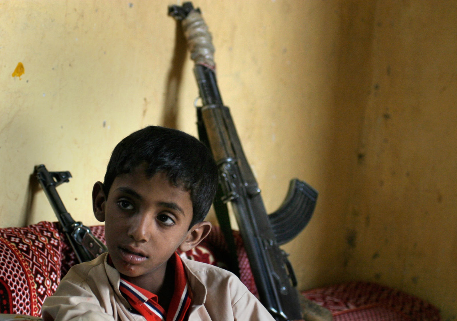 Yemen: Surviving Tribal Wars - A young boy listens as tribal leaders meet, chew khat,...