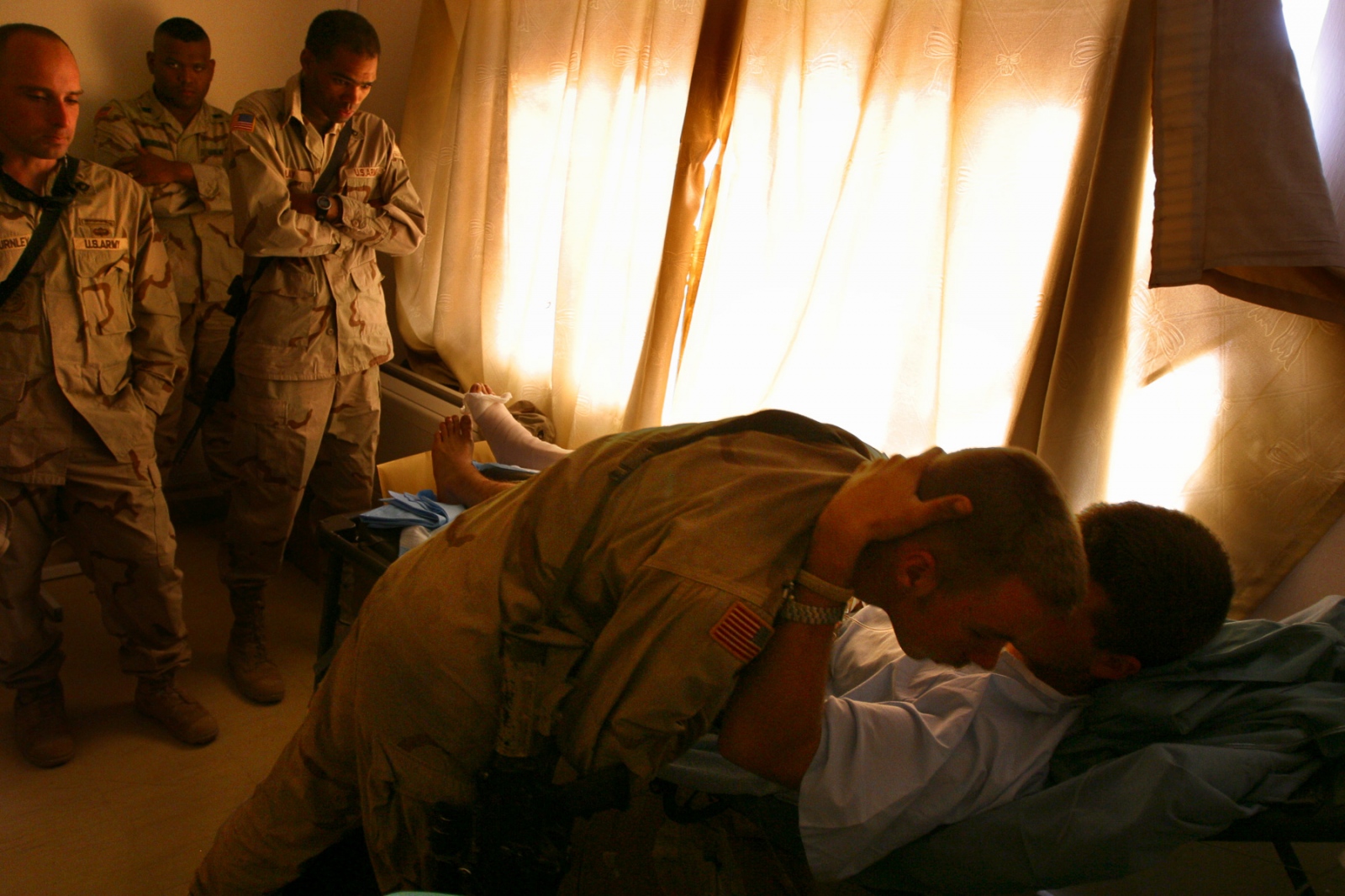 War's Toll on Iraq, 2003 -                                 Spec Ronald Dekker hugs...