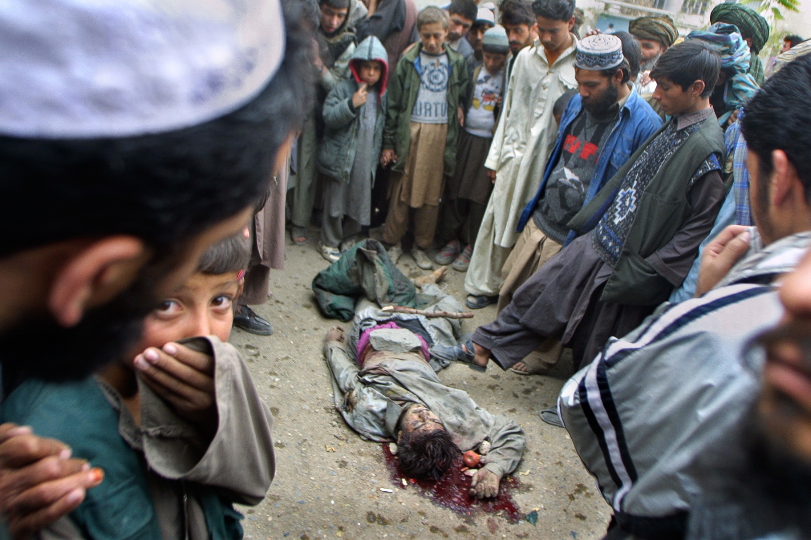 Onward to Kabul - Crowds mill around the bodies of foreign troops killed by...