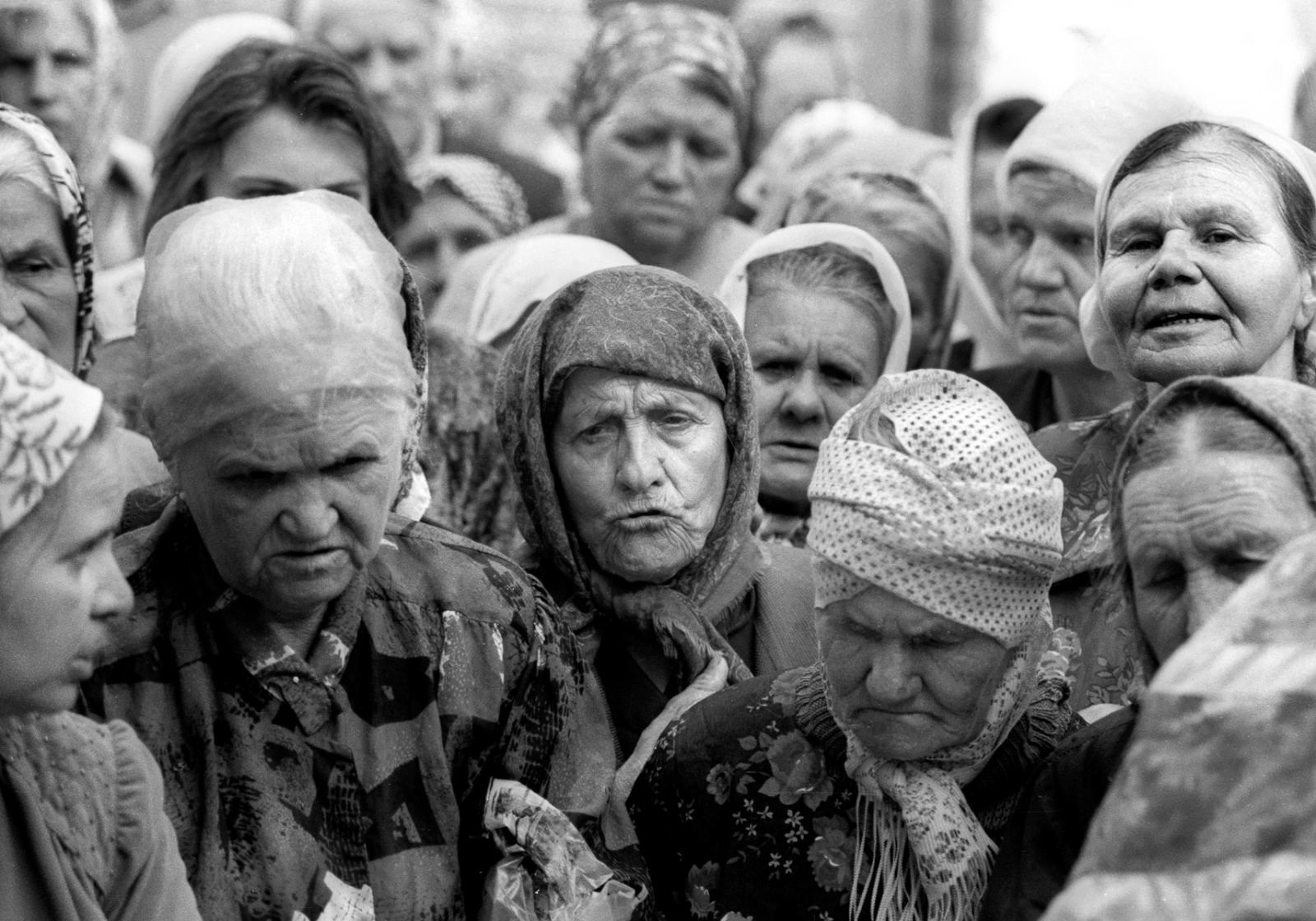 Forgotten Wars - Russian women attend a church service in their destroyed...