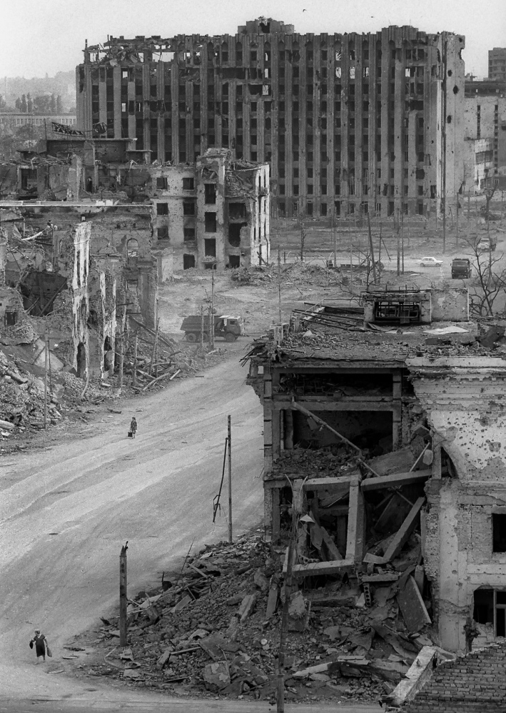 Forgotten Wars - A woman walks through the destroyed downtown of Grozny.
