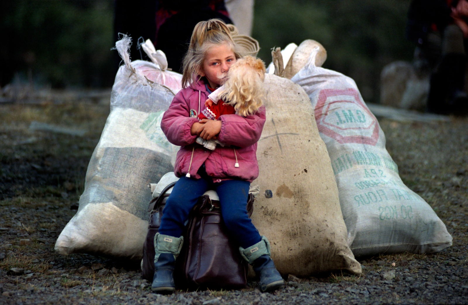Forgotten Wars - A girl guards her family's belongings, as her parents...