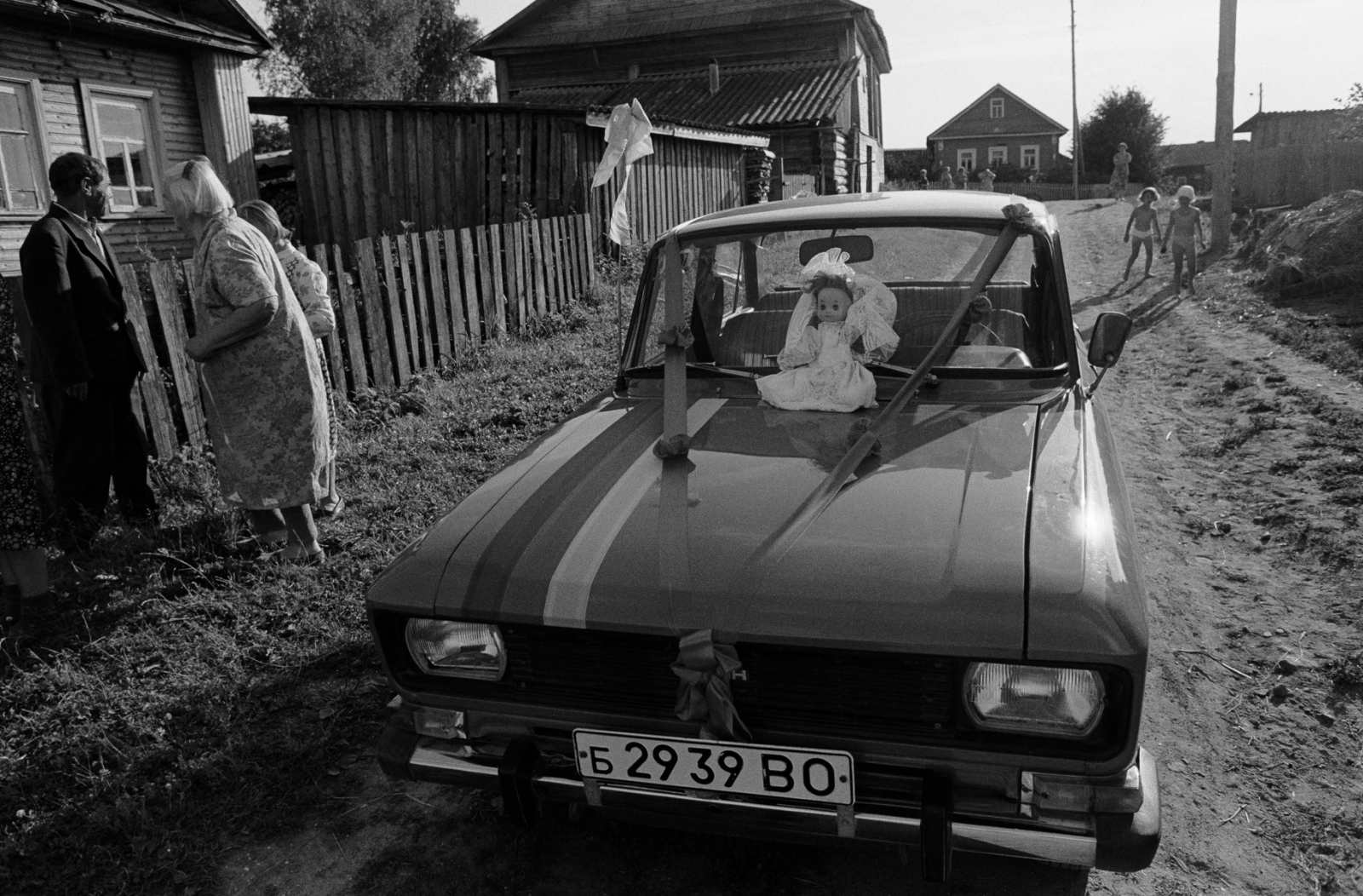 Russia - The Village of Anufrievo - A wedding couple bring their car to the village to...