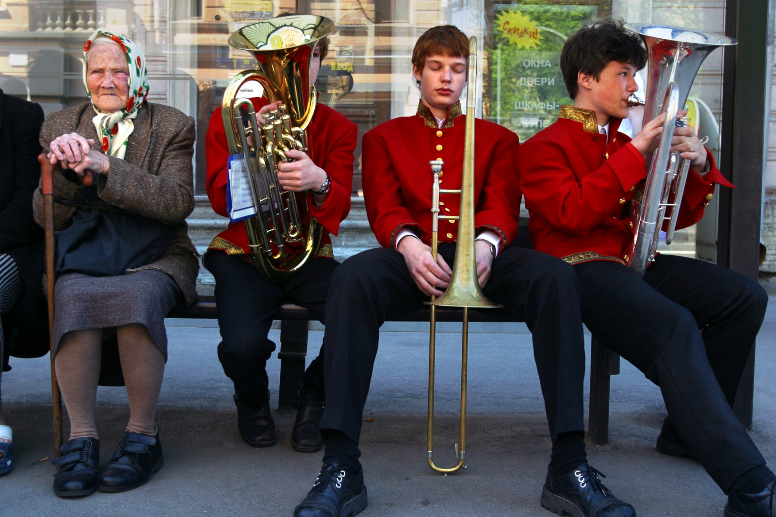 Russia - St. Petersburg Celebrates -                 Exhausted band members wait at a bus stop...