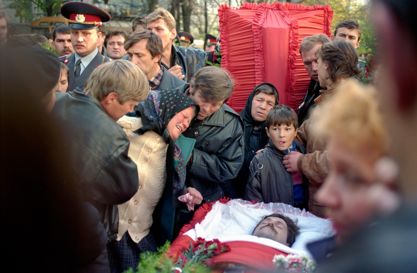 Russia In Transition - 1990s - A mother weeps during the funeral of her son, a member of...