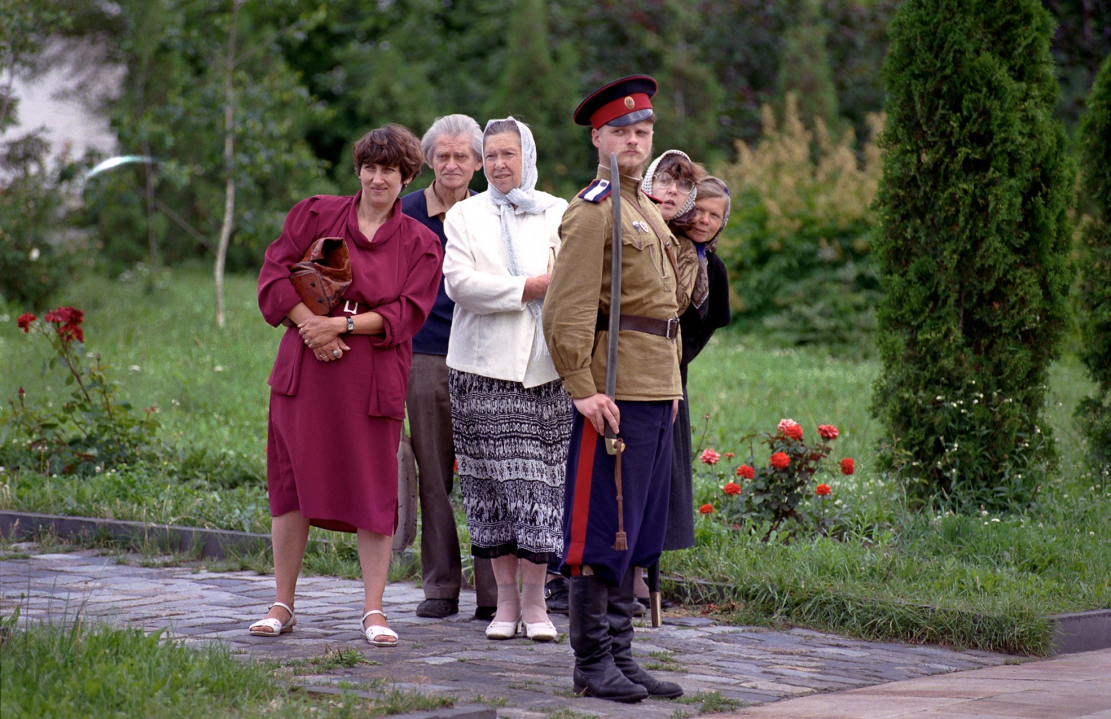 Russia In Transition - 1990s - A Cossack soldier and bystanders watch the Russian...