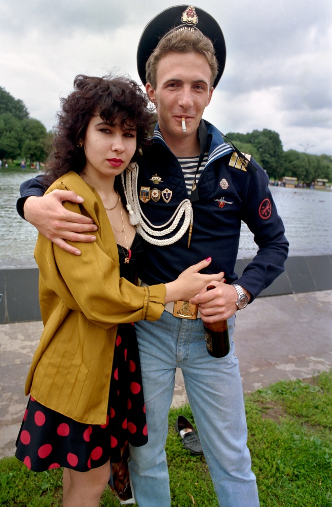 Russia In Transition - 1990s - A sailor poses with his girlfriend during Sailors Day in...