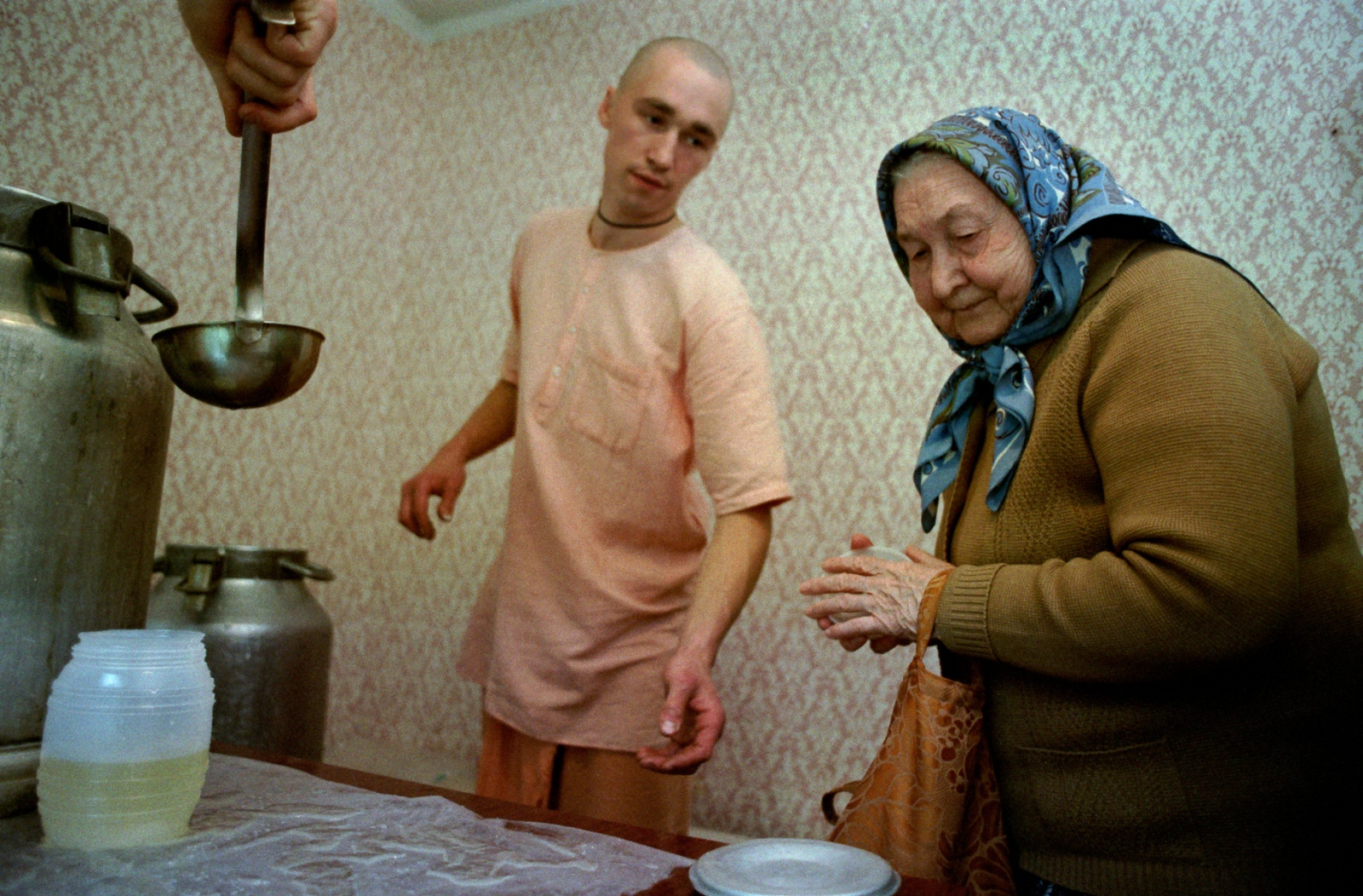 Russia In Transition - 1990s - An elderly pensioner gets a meal of soup and bread in...