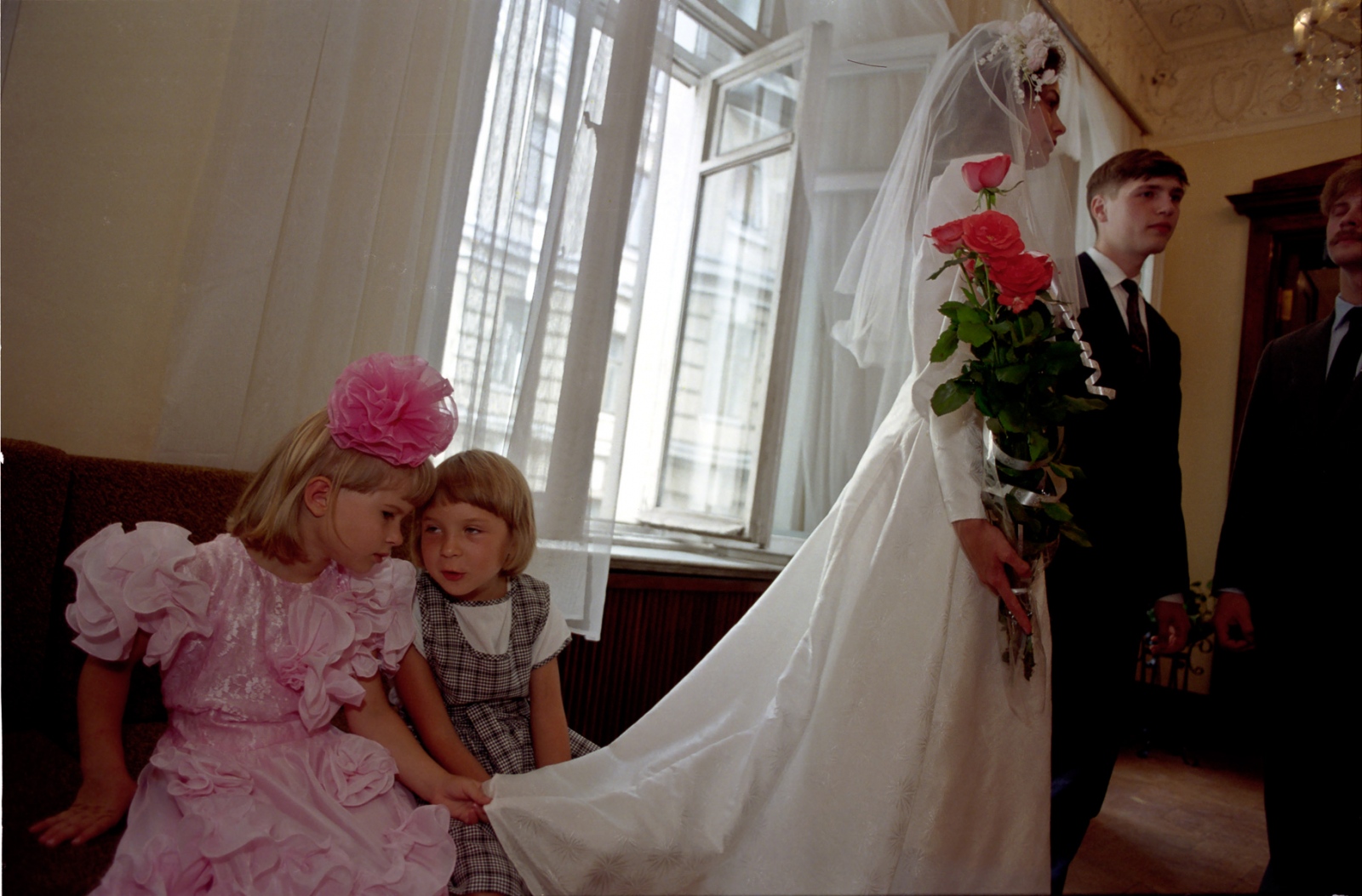 Russia In Transition - 1990s - Two young girls confer during a wedding in Moscow.