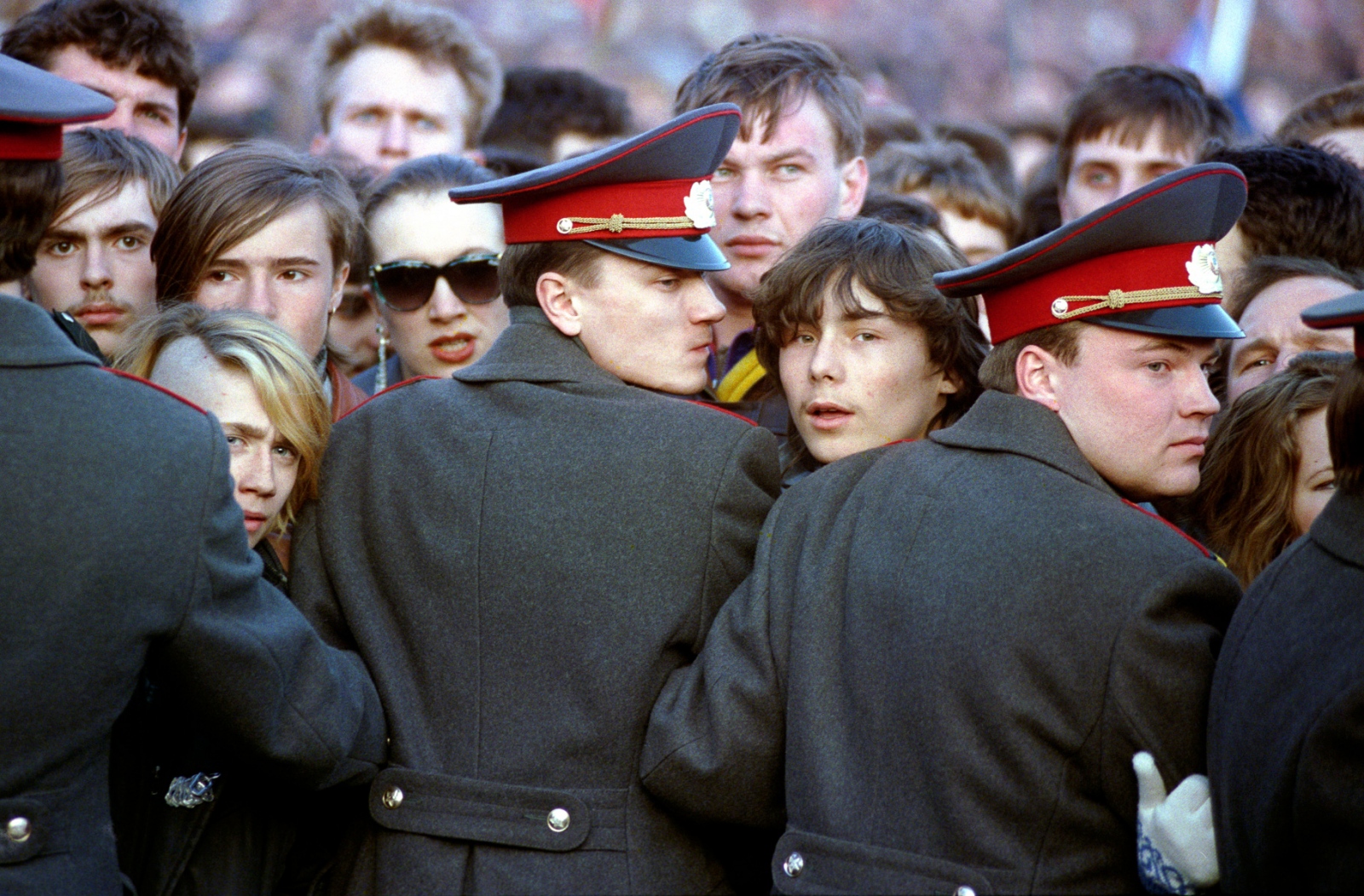 Russia In Transition - 1990s - Young Russians crowd up against militiamen guarding the...