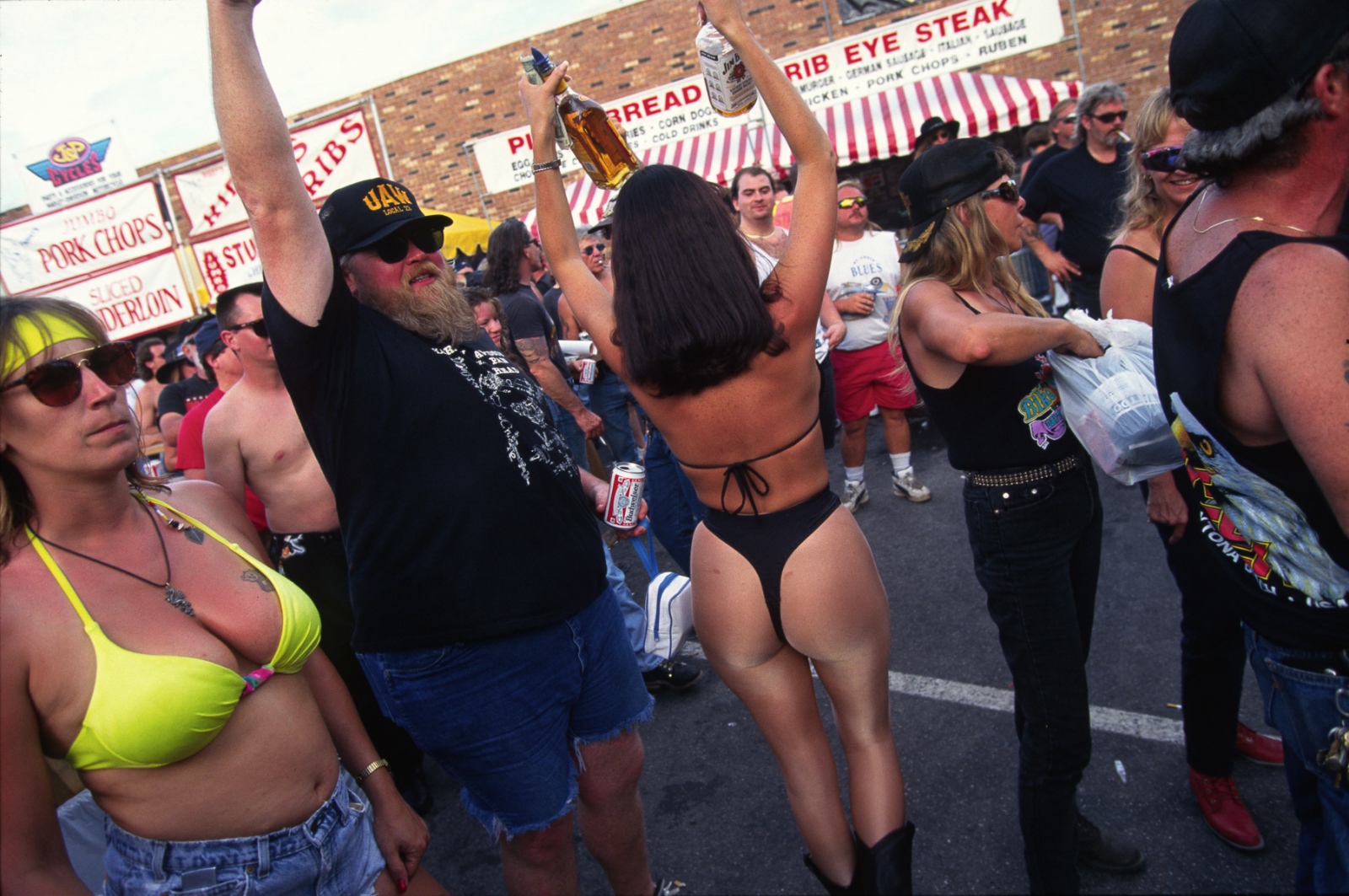 Bike Week - A waitress serves up shots of tequila and Bourbon to the...