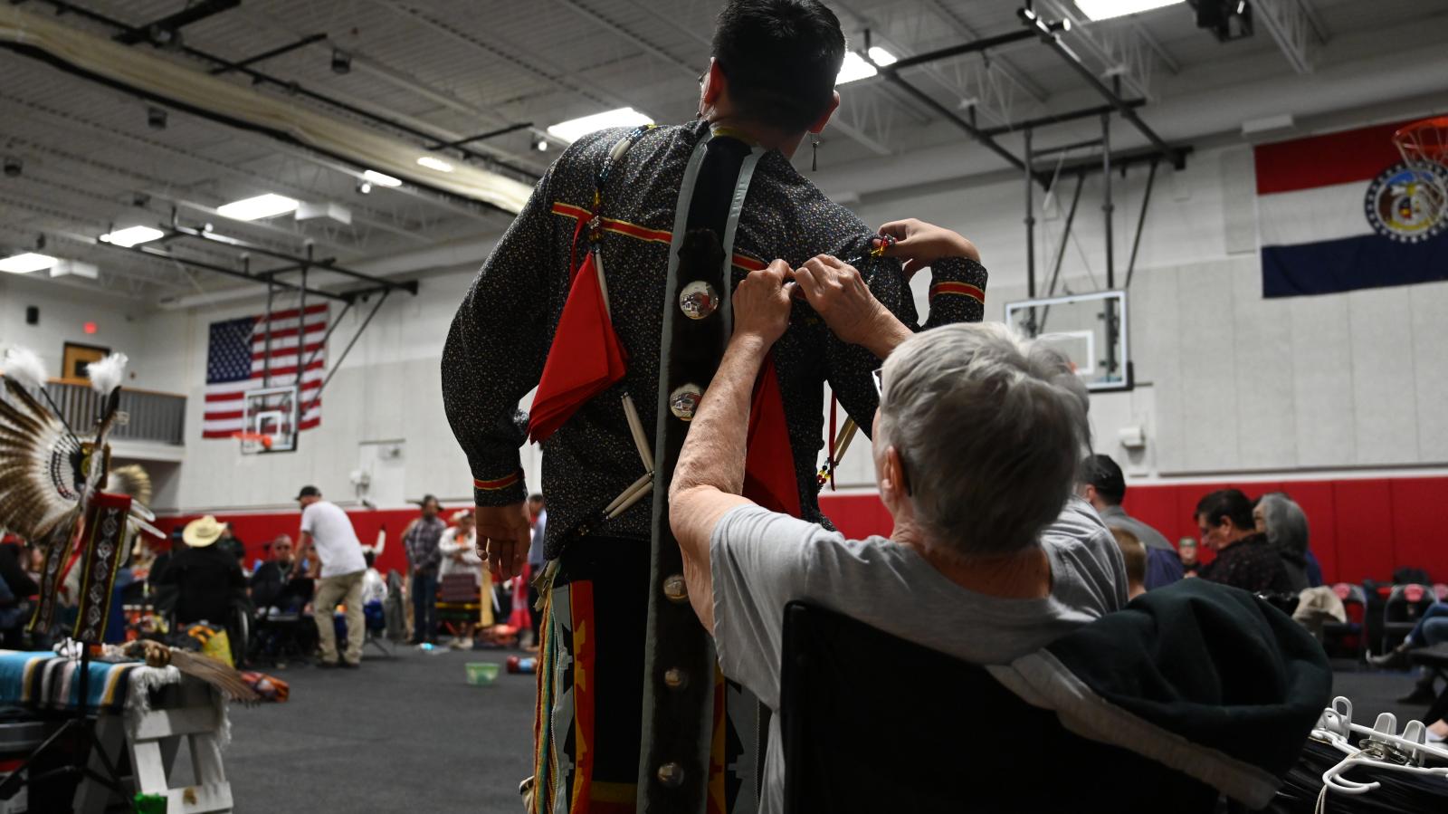 photo story - Smith's grandmother helps him with his regalia on...
