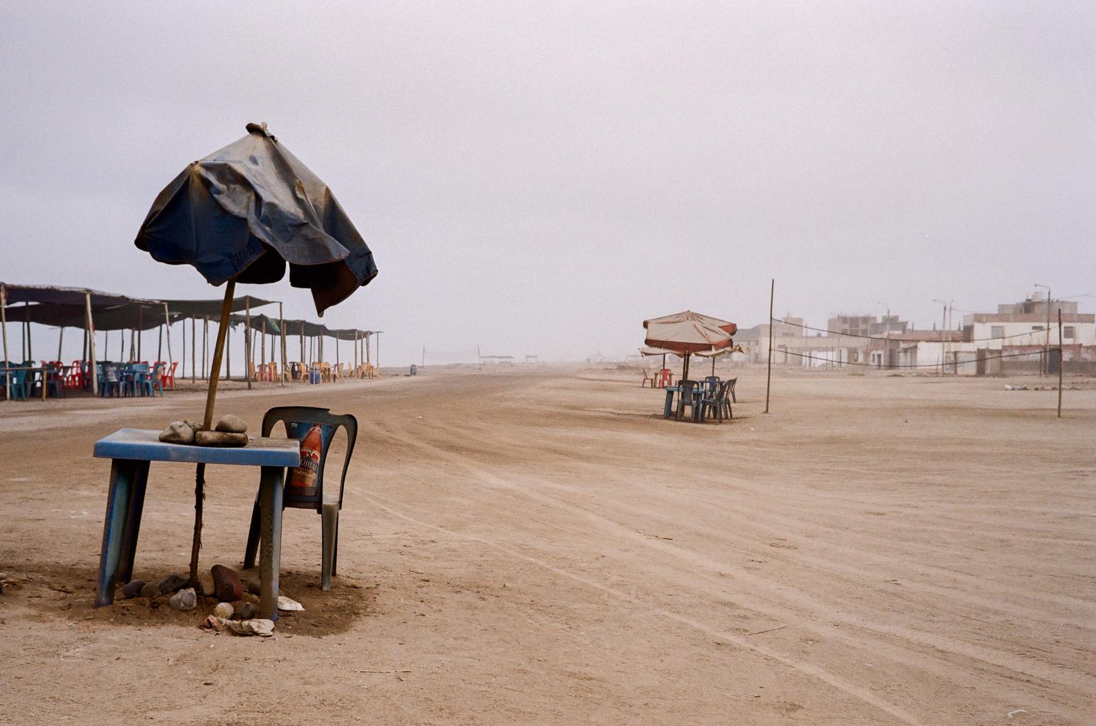 Drought -  Plastic chairs and tables, now covered in dust, sit unused along the coast in Huanchaquito. Once...