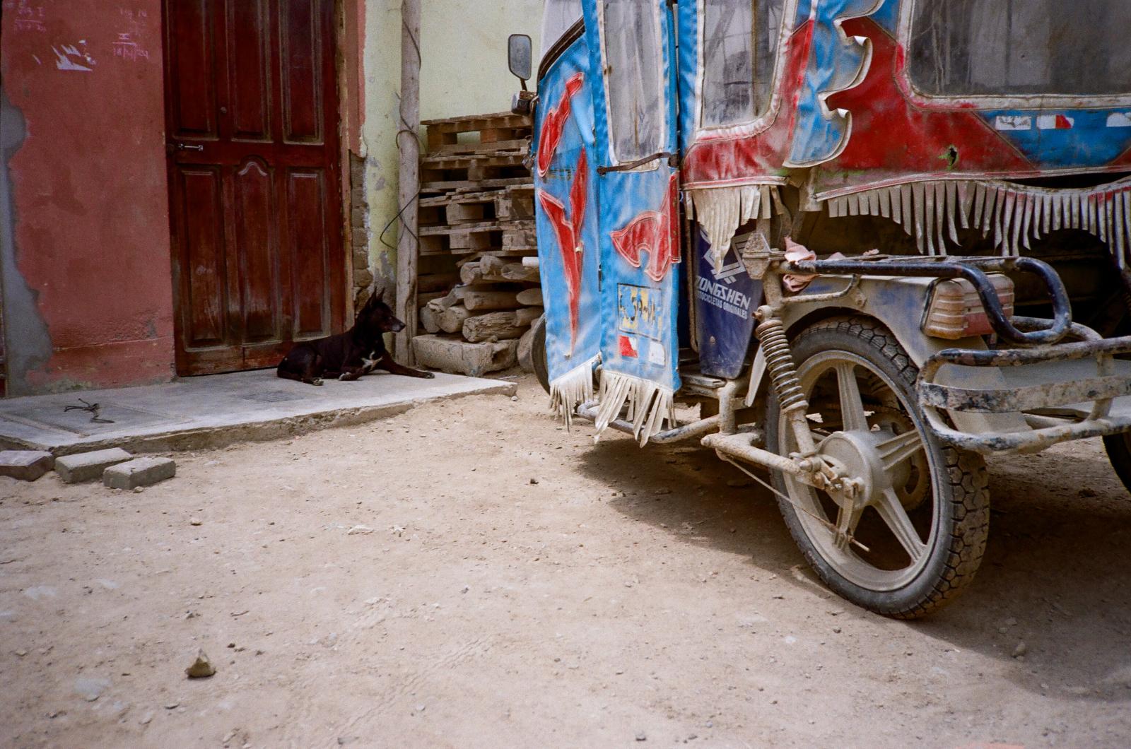 Drought -  A stray dog sits in front of a house beside a dust-covered mototaxi in Huanchaco. In northern...