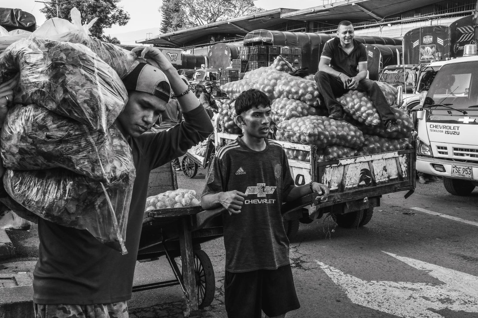 Carga: The Weight They Carry -  Beyond the physical burdens, migrants often face social challenges, including discrimination. In...
