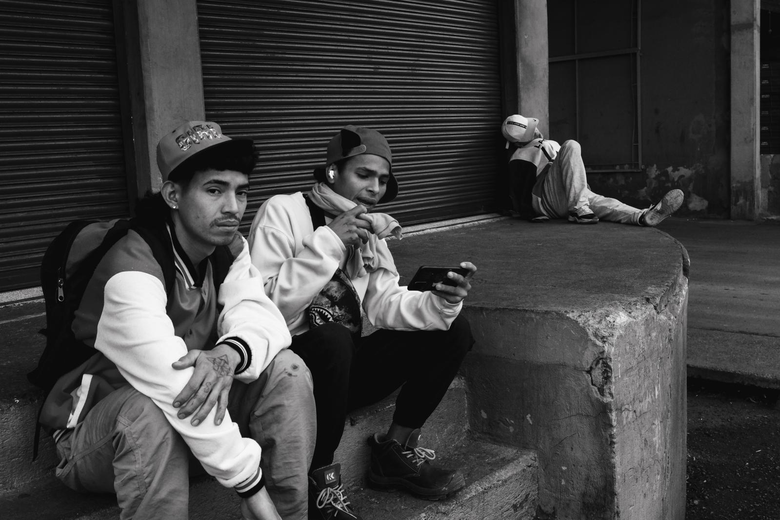 Carga: The Weight They Carry -  For many young migrants, steady work is never guaranteed. Each day is a gamble - a precarious...