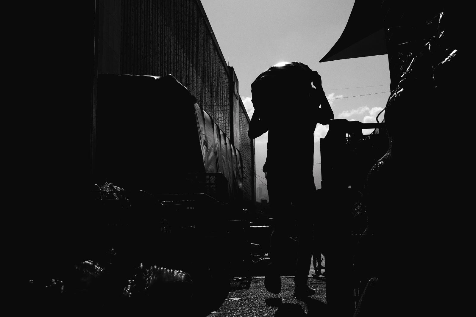 Carga: The Weight They Carry -  Each day, about 9,000 tons of food pass through Plaza Mayorista - much of it carried by hand,...