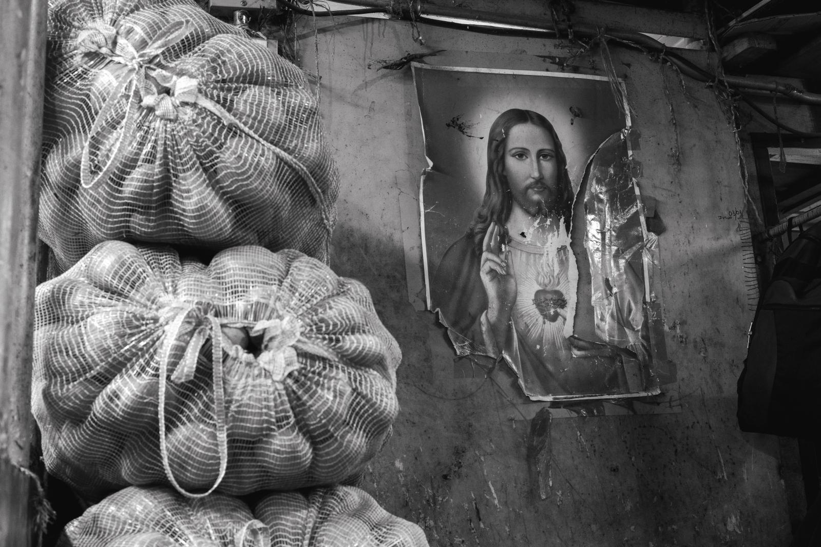 Carga: The Weight They Carry -  Torn, taped, and worn — this image endures. It quietly carries the hope and faith migrants cling...