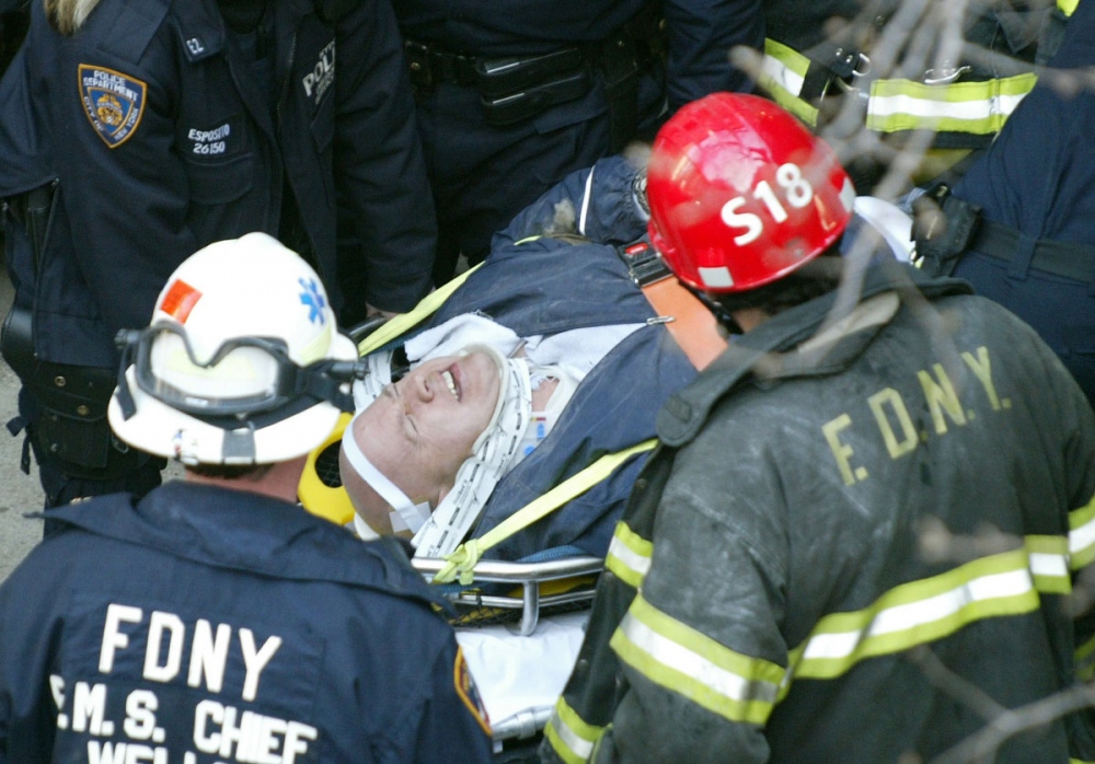   Members of the FDNY and NYPD remove an injured&nbsp;worker from a construction site after a wall collapsed on a building being demolished in Midtown&nbsp;Manhattan.&nbsp;  