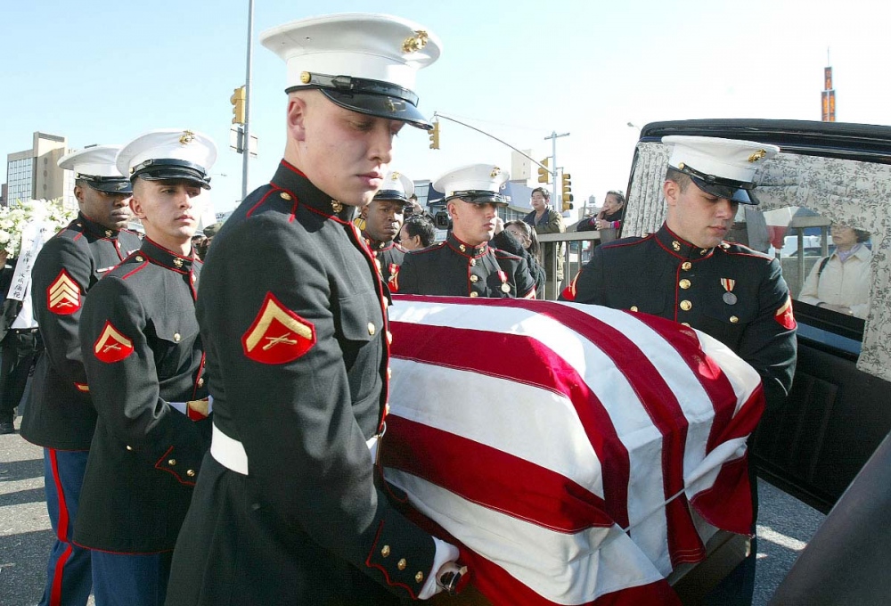   U.S. Marine pallbearers carry the flag drapped casket with U.S. Marine Lance Corporal Patrick Lam body during a burial ceremony in Queens, New York.  
