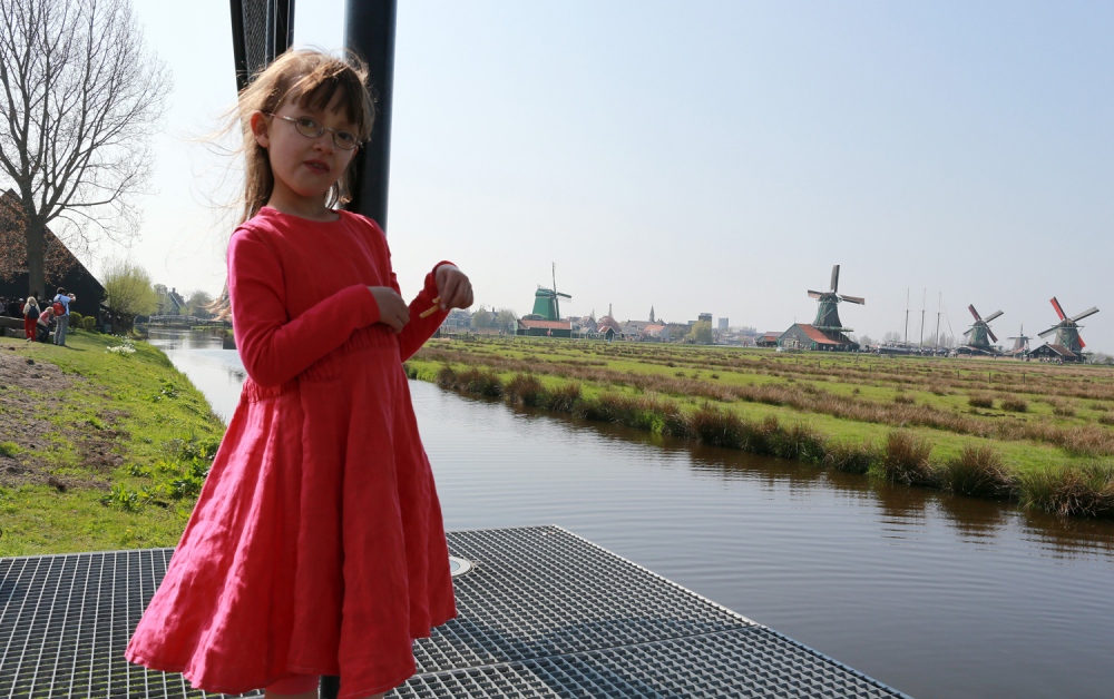  Five years old Hannah Doornenbal pauses from playing with her sisters near a dyke overlooking the Zaanse Schans a fully inhabited, open-air conservation area and museum a few miles north of Amsterdam. 