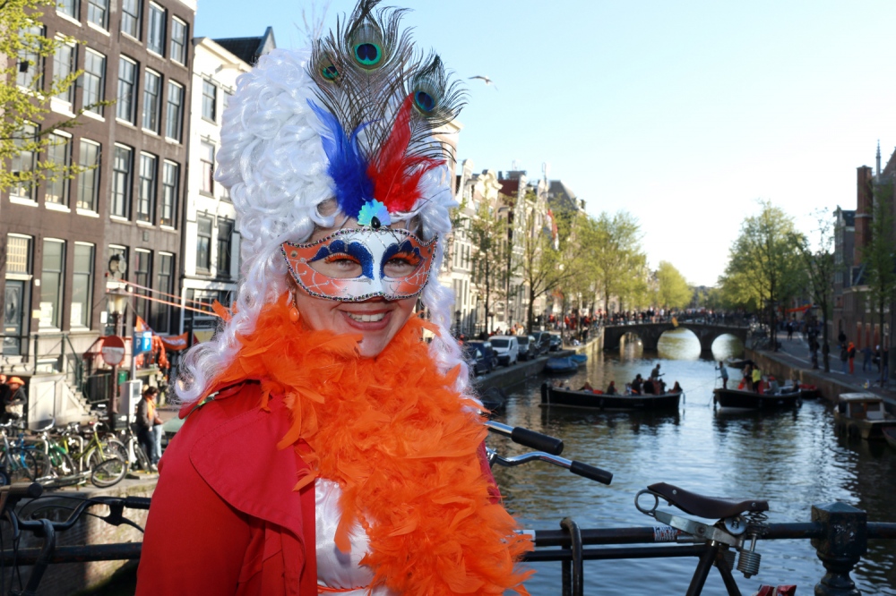  A unidentified reveler celebrates Koningsdag or King's Day on a bridge in Amsterdam. 