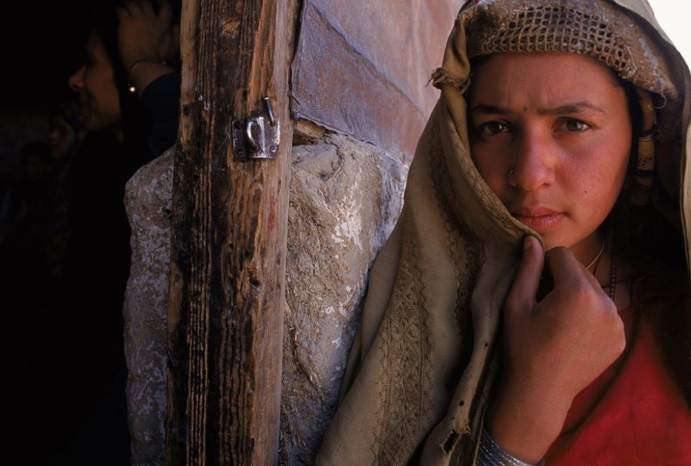 Kabul, 1998.Â Â A young woman outside a widows bakery.