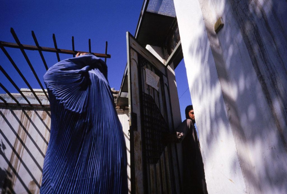 Image from Afghanistan - Kabul, 1998.Â  A woman enters a compound to attend a...