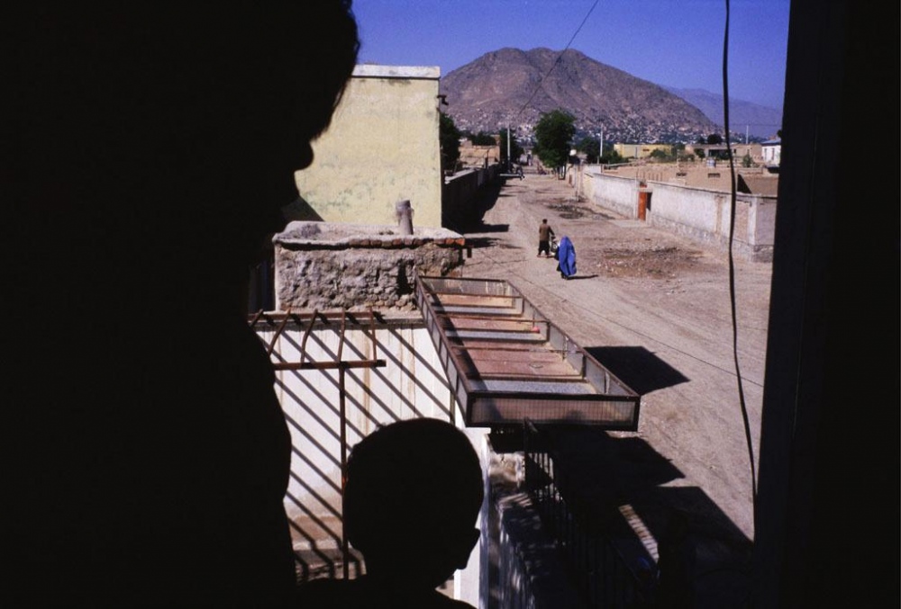 Image from Afghanistan - Kabul, 1998.Â  A woman and her child peer out a window.Â...