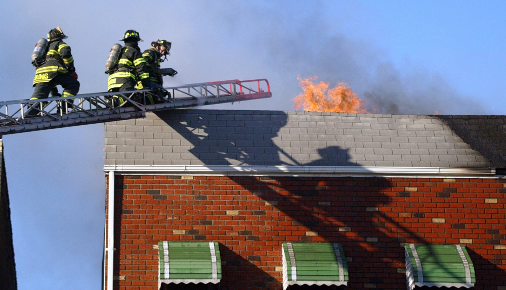 Photojournalism -   Firefighters work on a house fire in Brooklyn.  