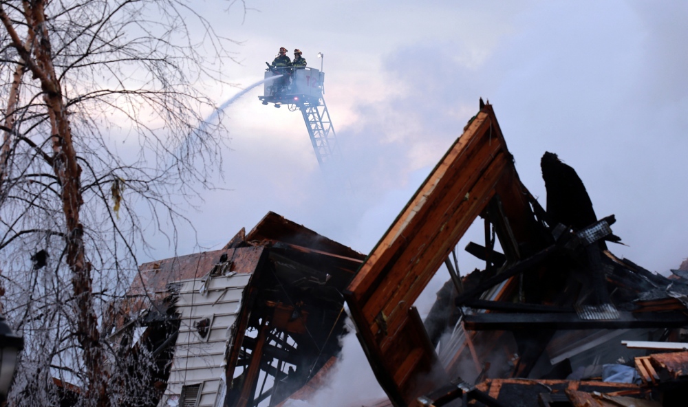 Image from Photojournalism -   Firefighters work on an apartment fire in...