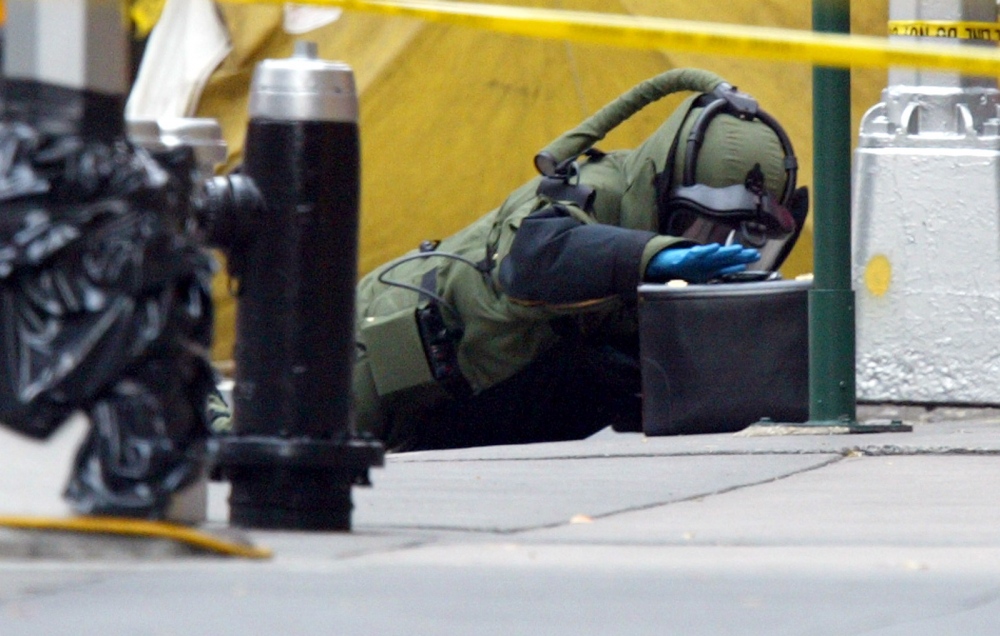   An NYPD Bomb Squad Technician&nbsp;check a suspicious bag in Midtown&nbsp;Manhattan.  