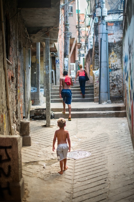 A young boy walks through the a...ncia in Rio de Janeiro, Brazil.