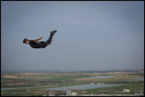    18 year old Fahed Dawood is airbourne over the Gaza Strip, Beit Hanoun, Northern Gaza Strip.Â Fahed is a member of the Gazan Parkour team '3 Run Gaza'.   