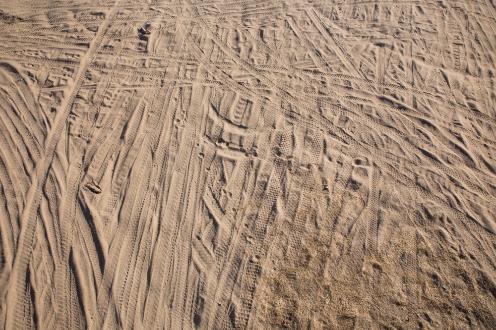 Tire tracks mark the sandy river bottom of the Kings River in Kings County, California. The...