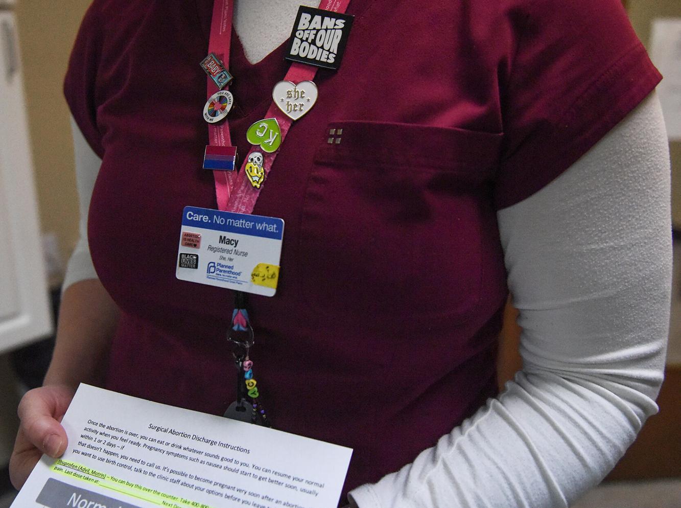 Macy Thompson, a registered nurse at Planned Parenthood, shows post-abortion information provided to patients on Monday at Planned Parenthood